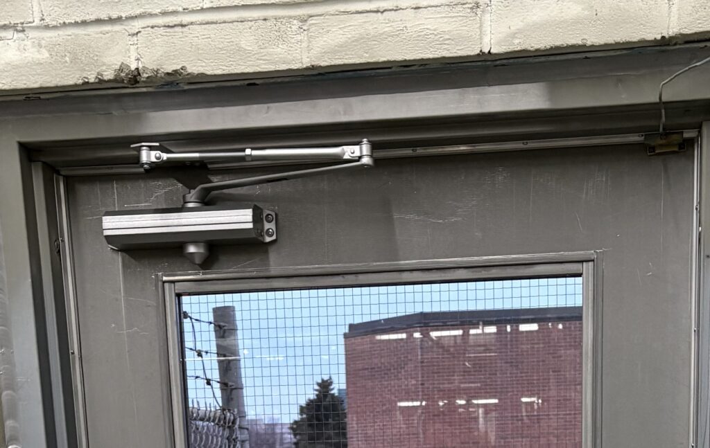 newly installed commercial door closer in a Toronto warehouse.