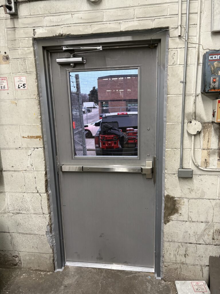 newly installed commercial door replacement for factory in Toronto.