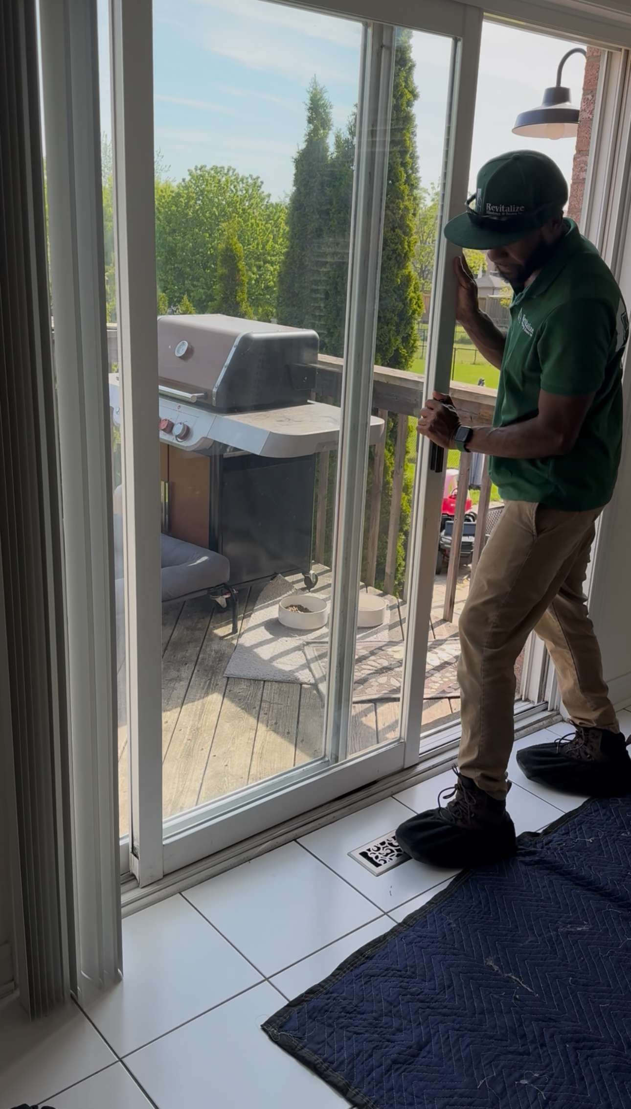 a door technician struggling to push a sticking patio door