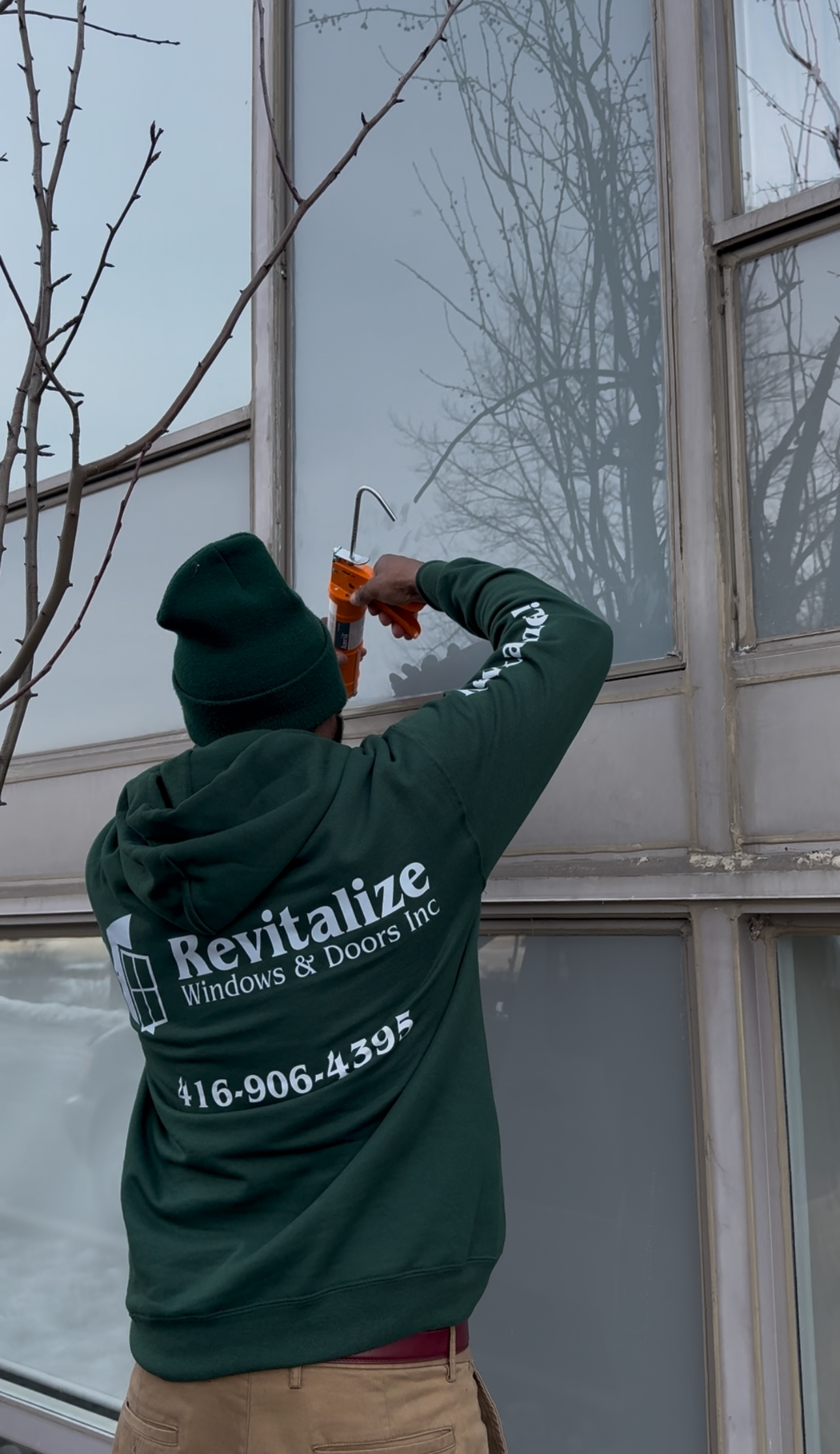 revitalize windows and doors technician applying caulking to window 