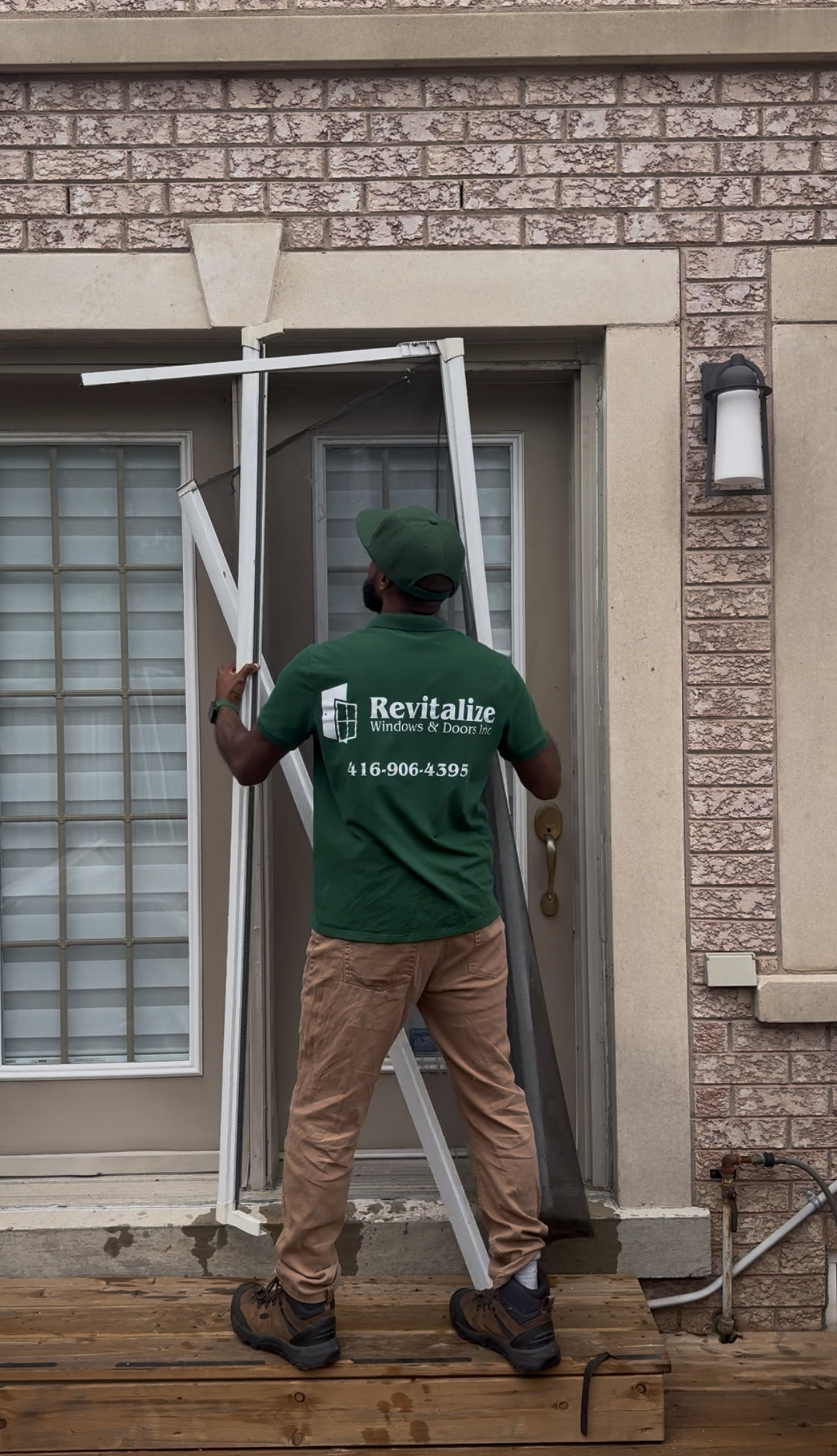 door technician removing old damaged screen door. 