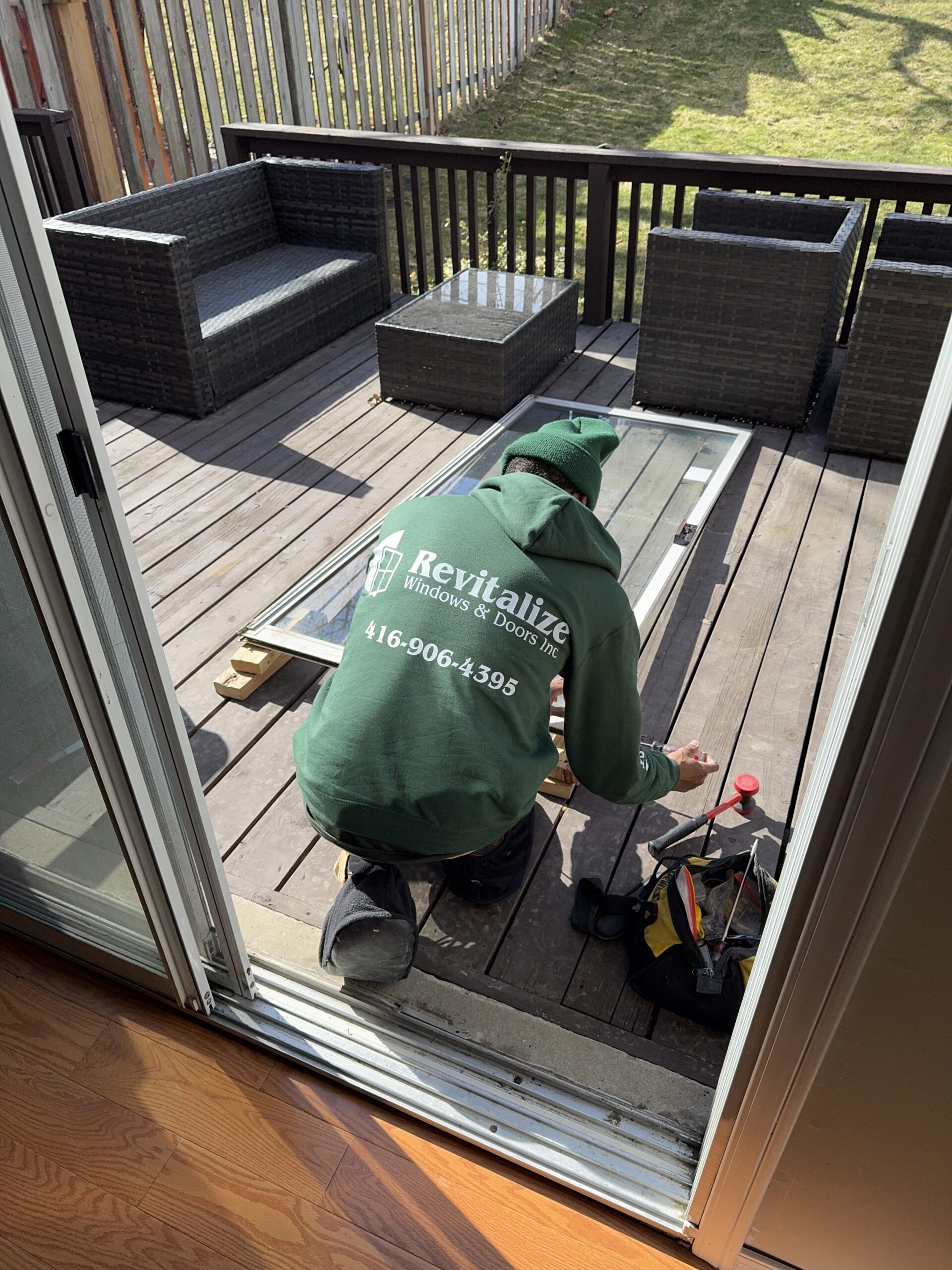 revitalize windows and doors technician repairing patio door.