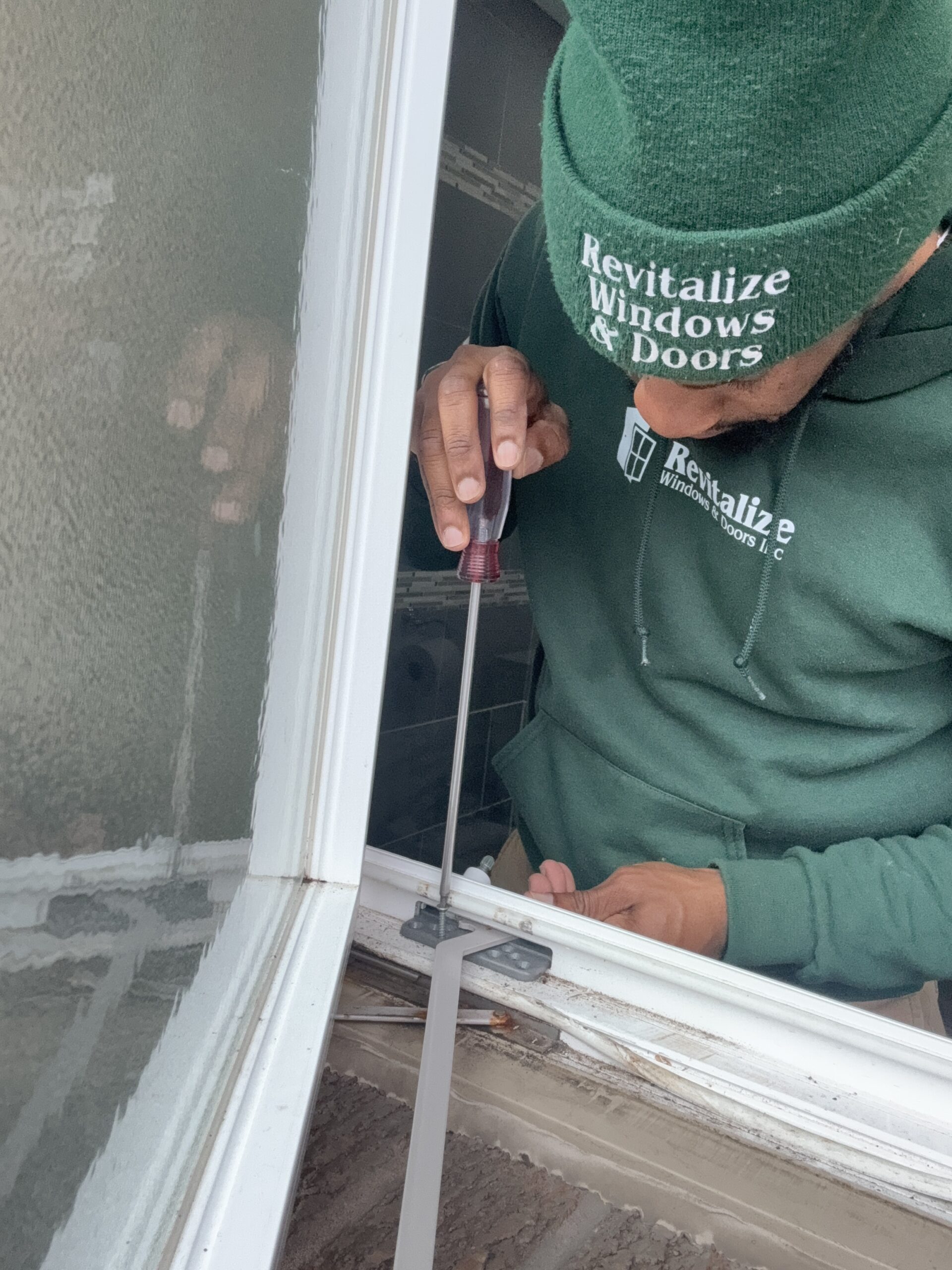 revitalize windows and doors technician replacing defective window crank.