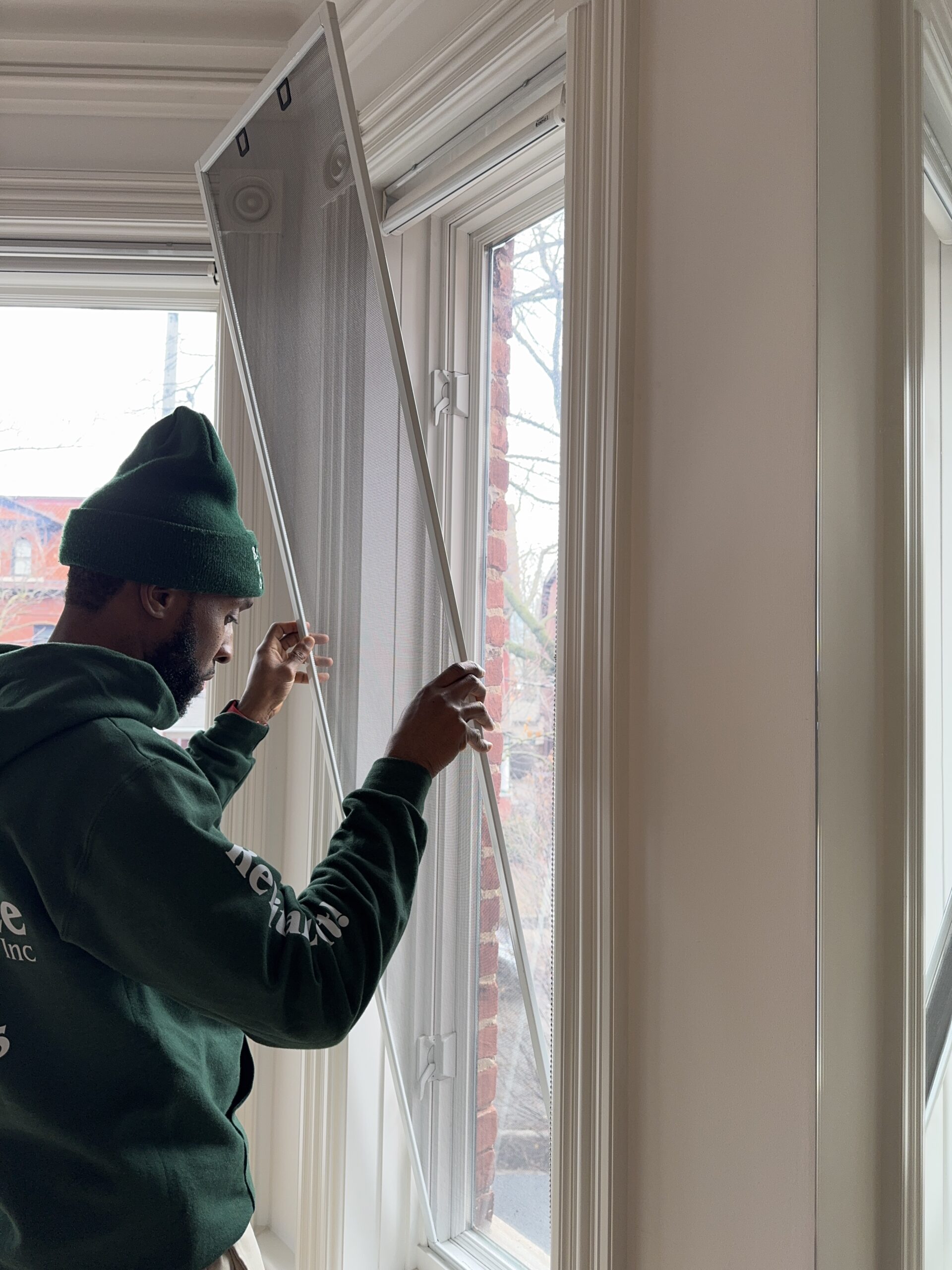 window technician installing new window screen