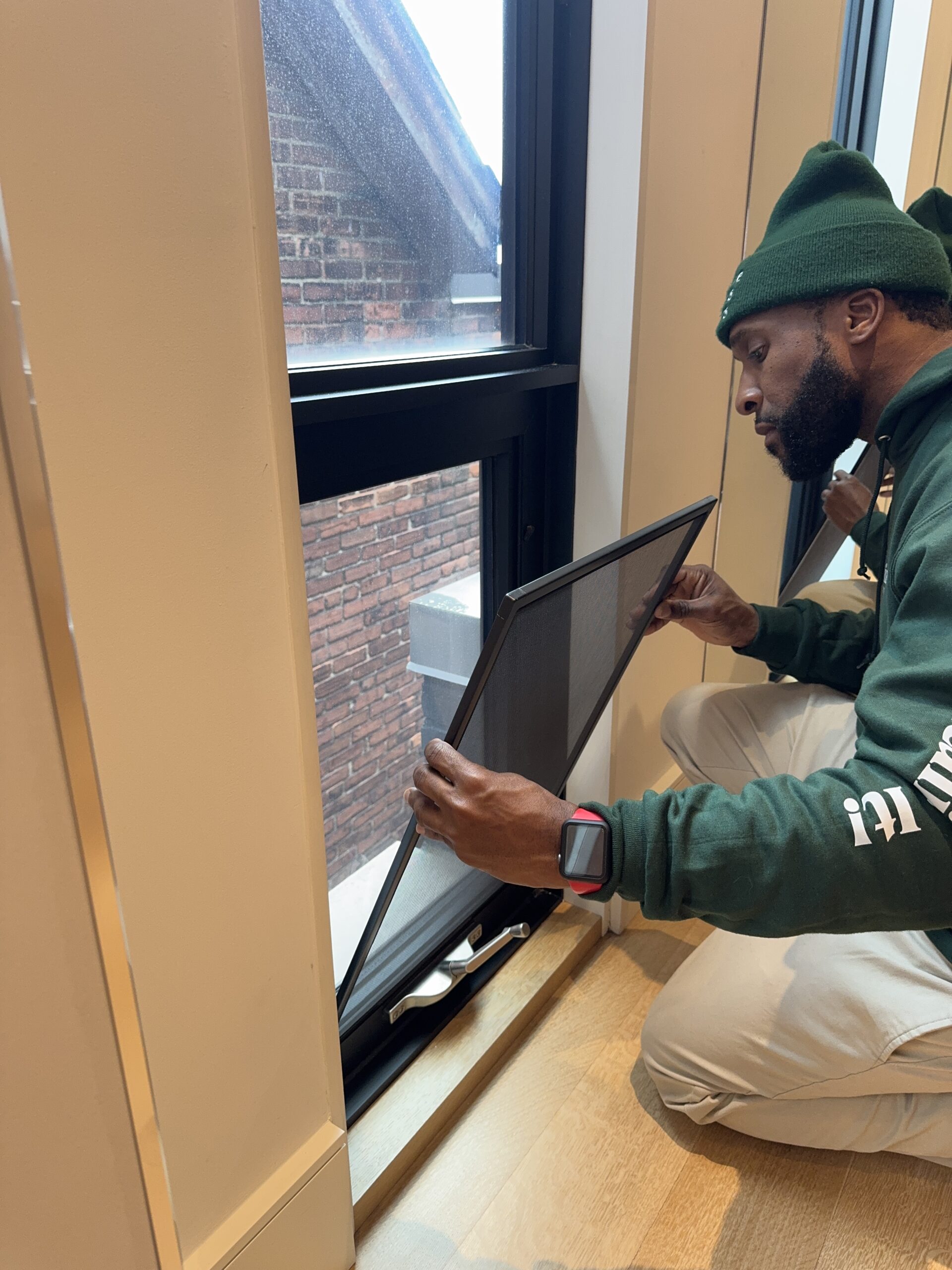 window technician installing new window screen