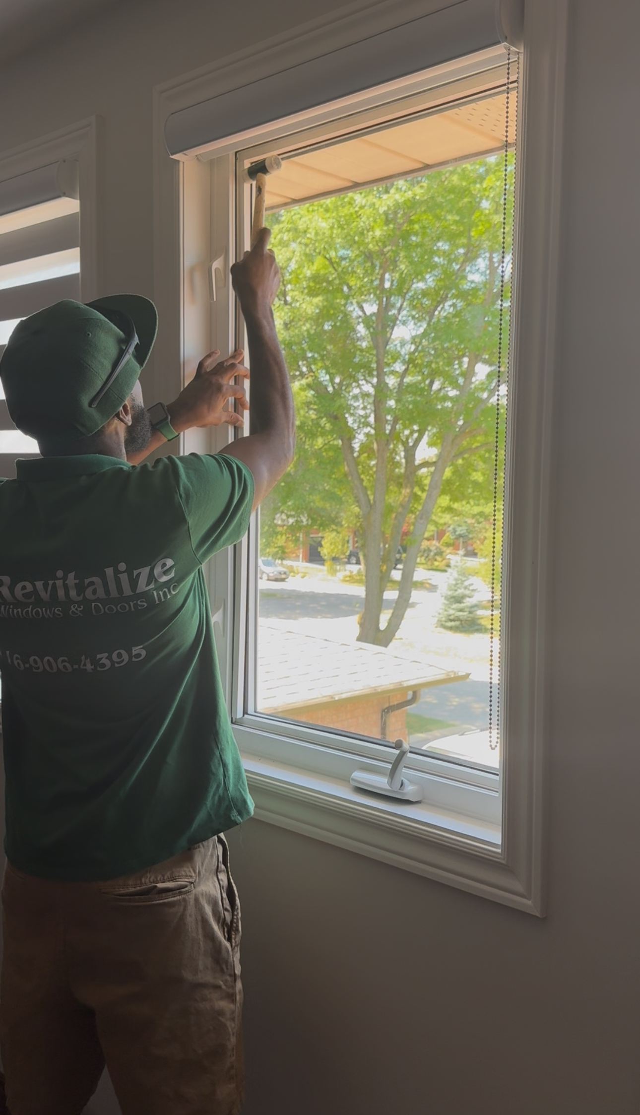 window technician, securing new replacement window pane.